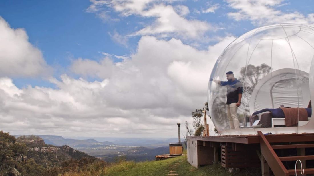 man in a bubble overlooking a canyon